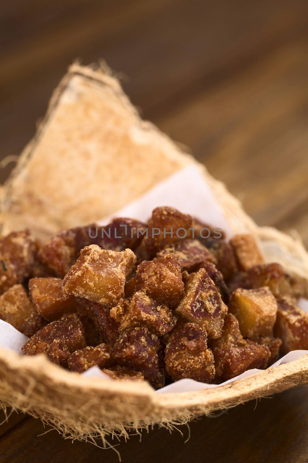 Peruvian coconut sweets sold usually on the streets, made of coconut pieces and brown sugar, which gives the sweet its brown color (Selective Focus, Focus one third into the sweets)