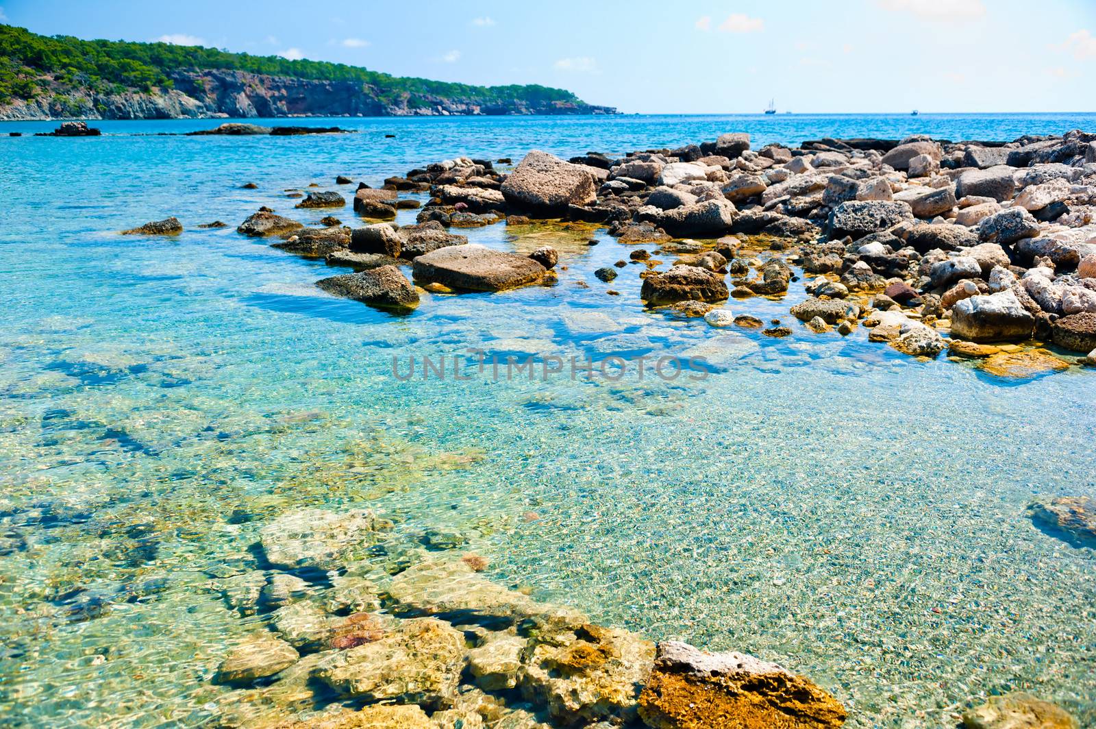 rocky bottom of the sea and a ship on the horizon