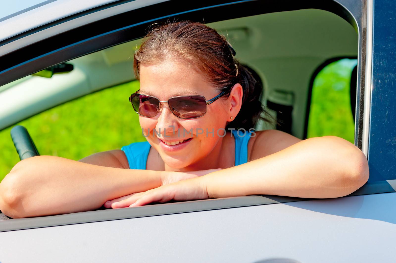 Pretty female driver in her new car