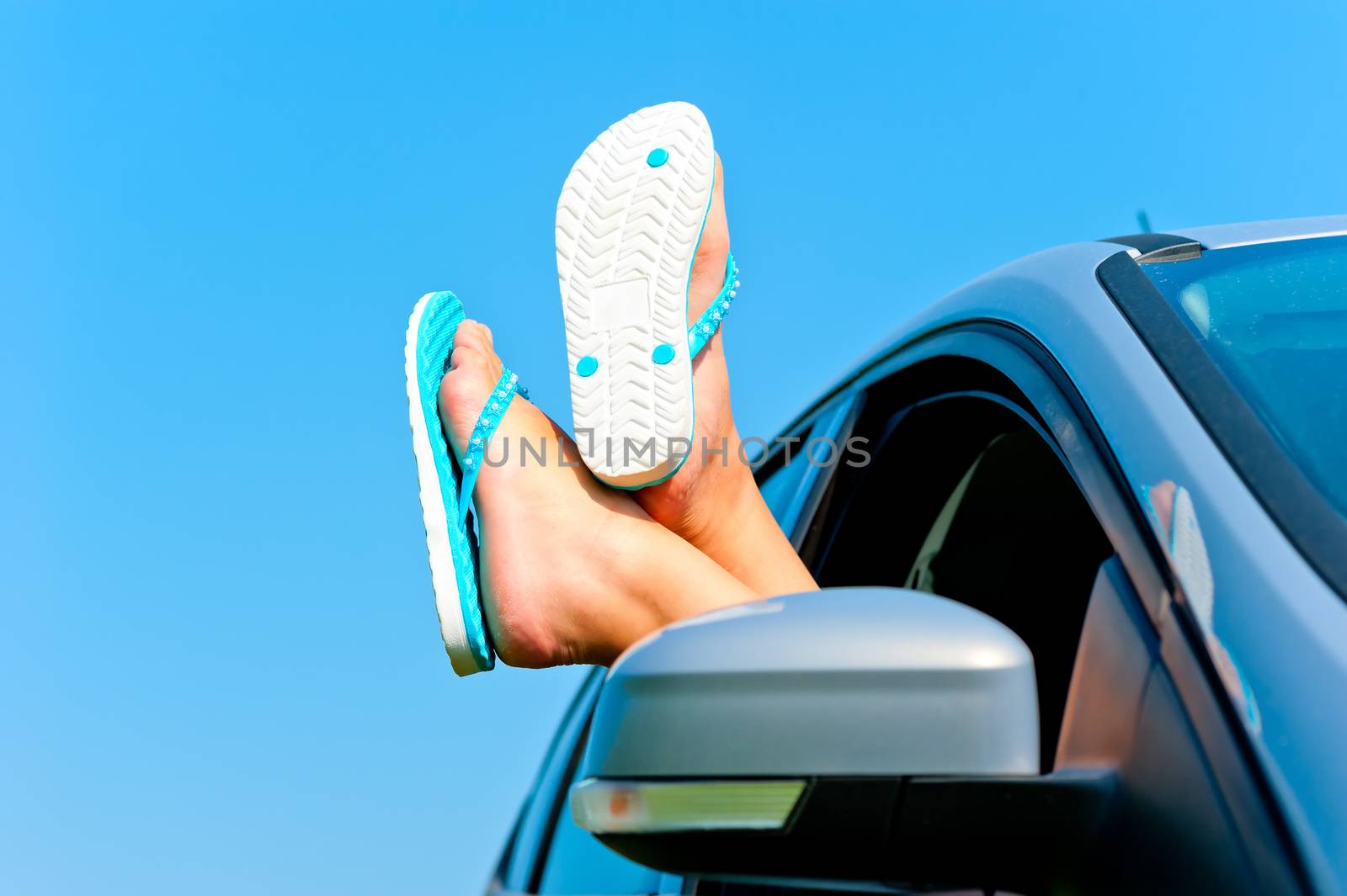 rest in autotravel - female legs in shales in the car