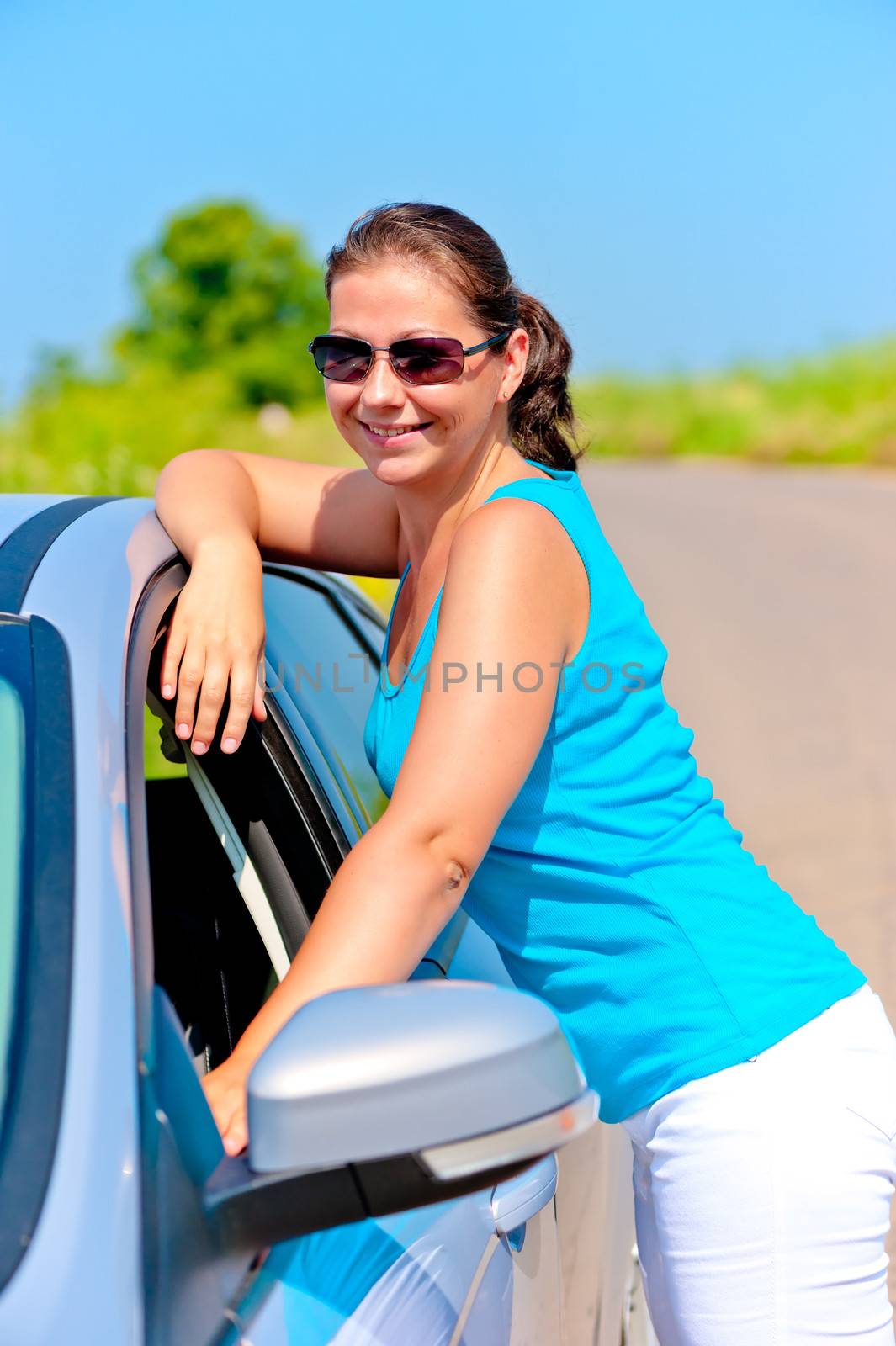 happy girl standing near her car on the road by kosmsos111