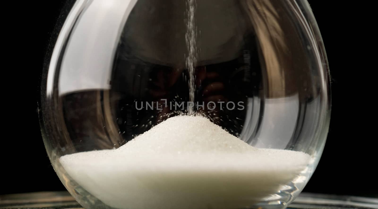 Sand Falling in Hourglass Close Up by ChrisBoswell