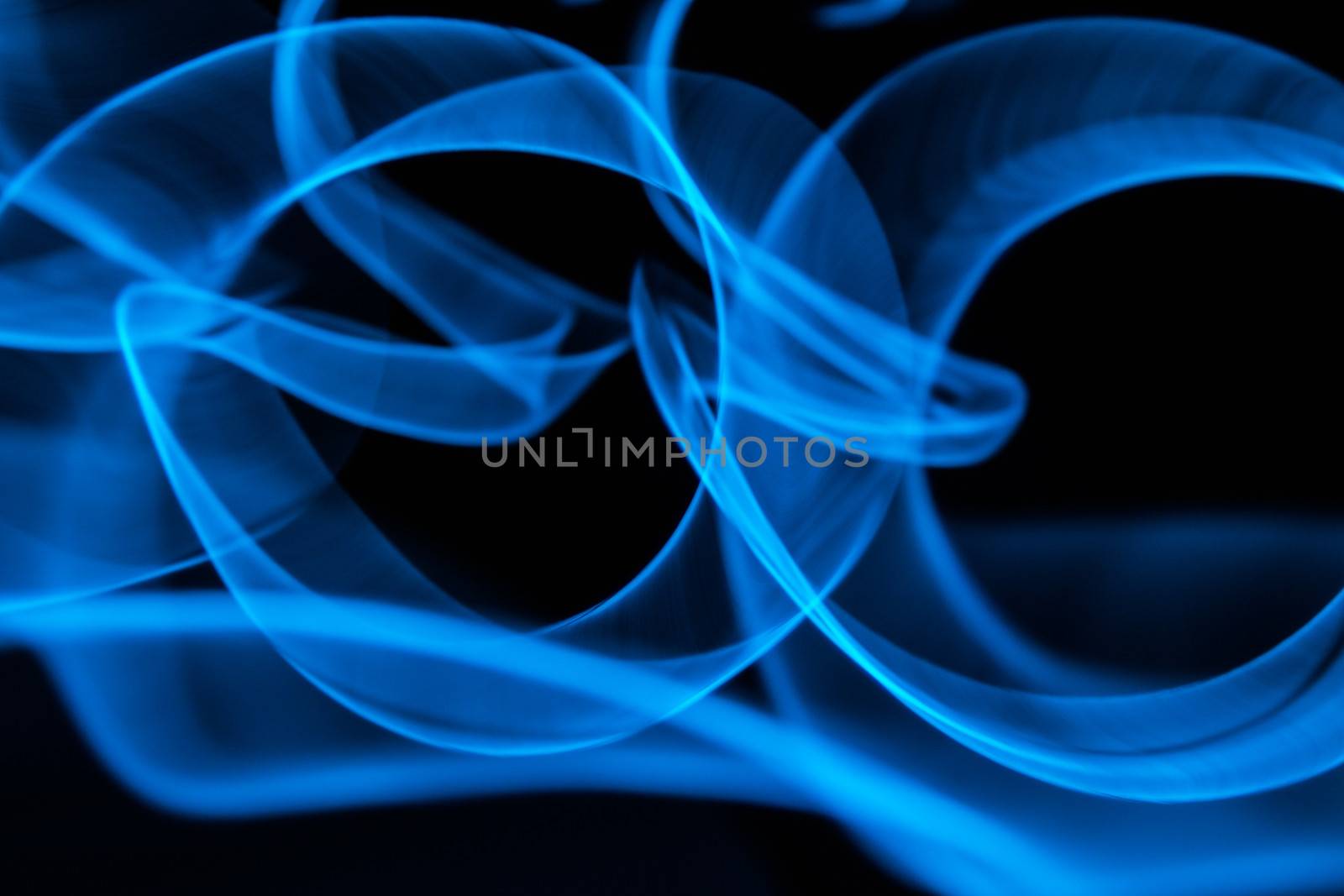 Curved bluish lines. Abstract wave forms of light in long exposure.