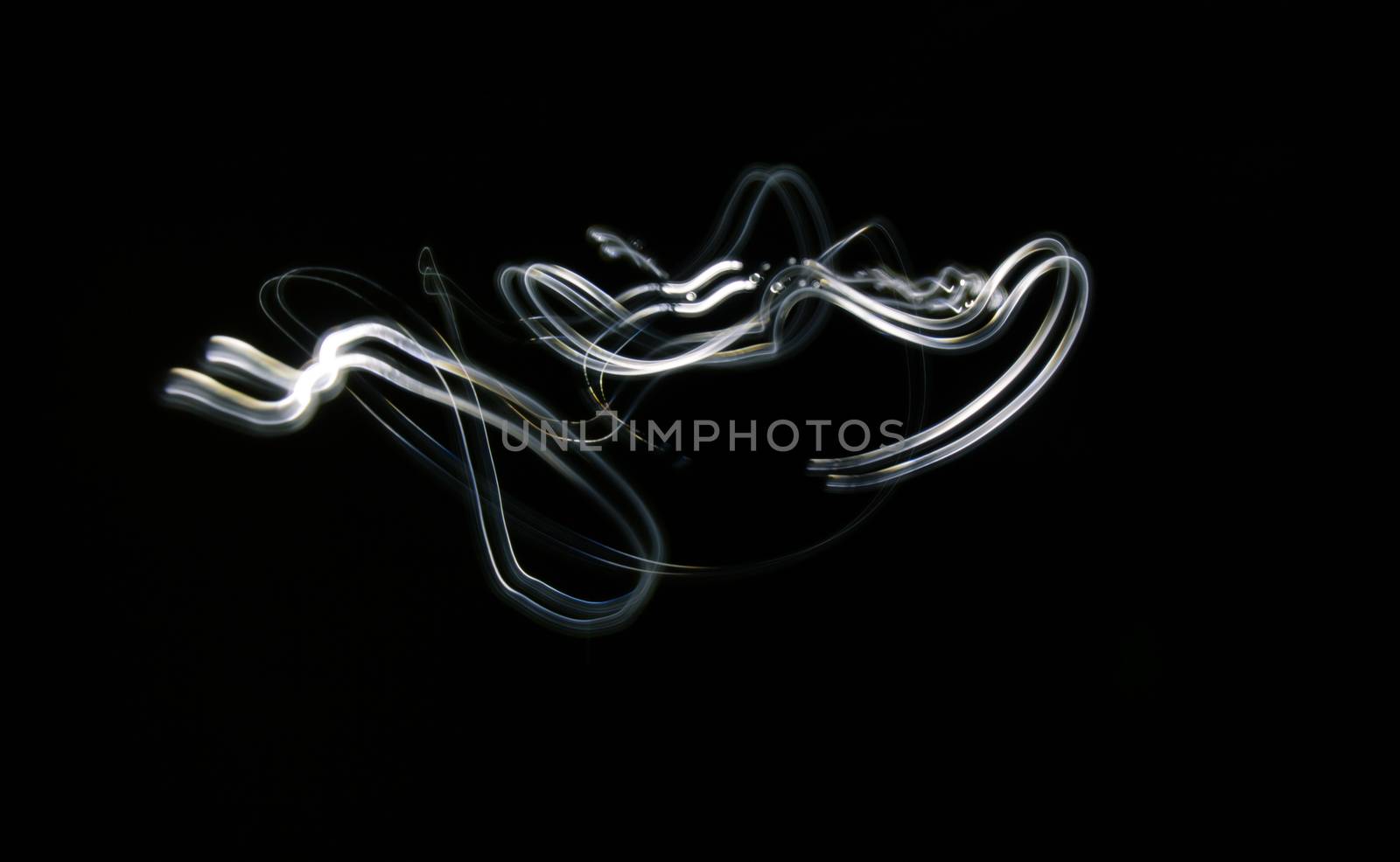 Curved white lines. Abstract wave forms of light in long exposure.