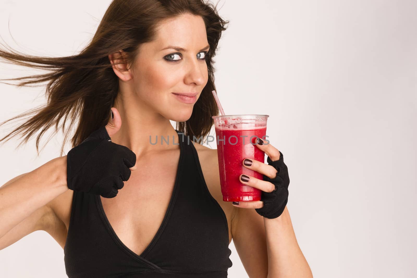 Attractive Athletic Female Shows Thumbs up Sign Holding Refreshing Blended Food Fruit Smothie Drink