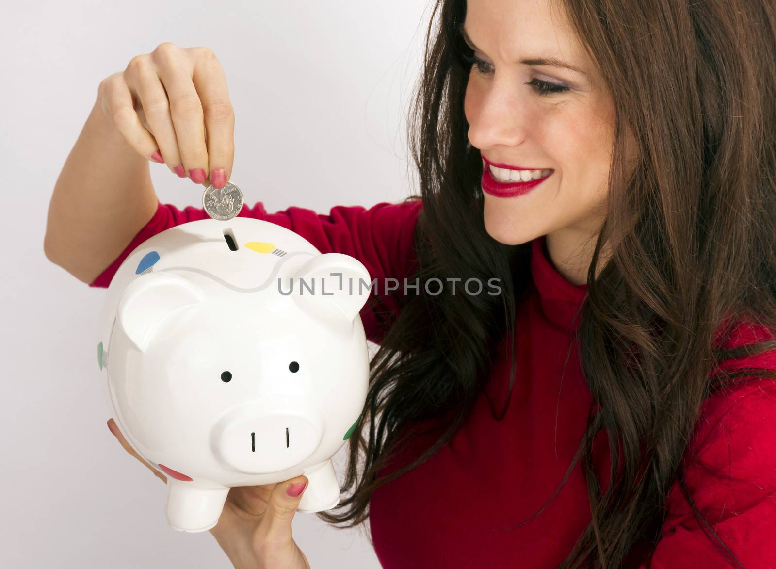 Pretty Happy Brunette Woman Drops Quarter Coin Savings Bank by ChrisBoswell