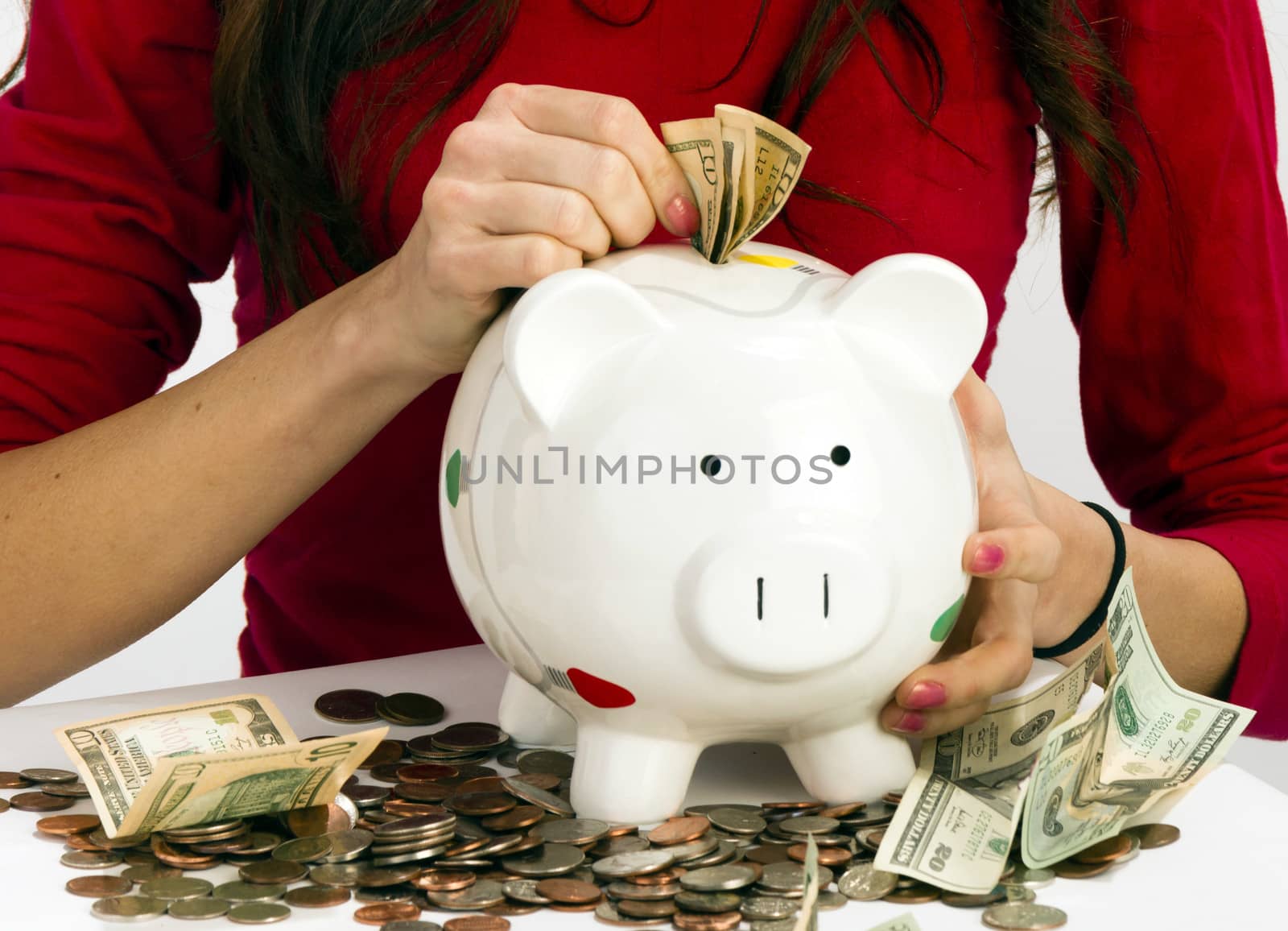 Woman saving money the old fashioned way in Piggy Bank