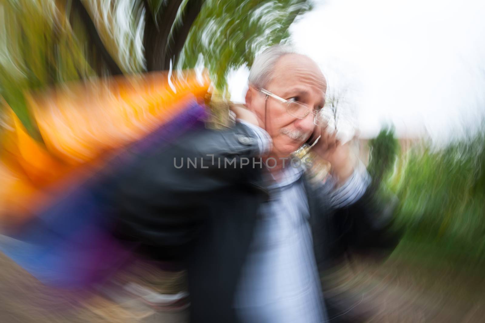 Holiday sales. An elderly man with many shopping bags in his han by palinchak