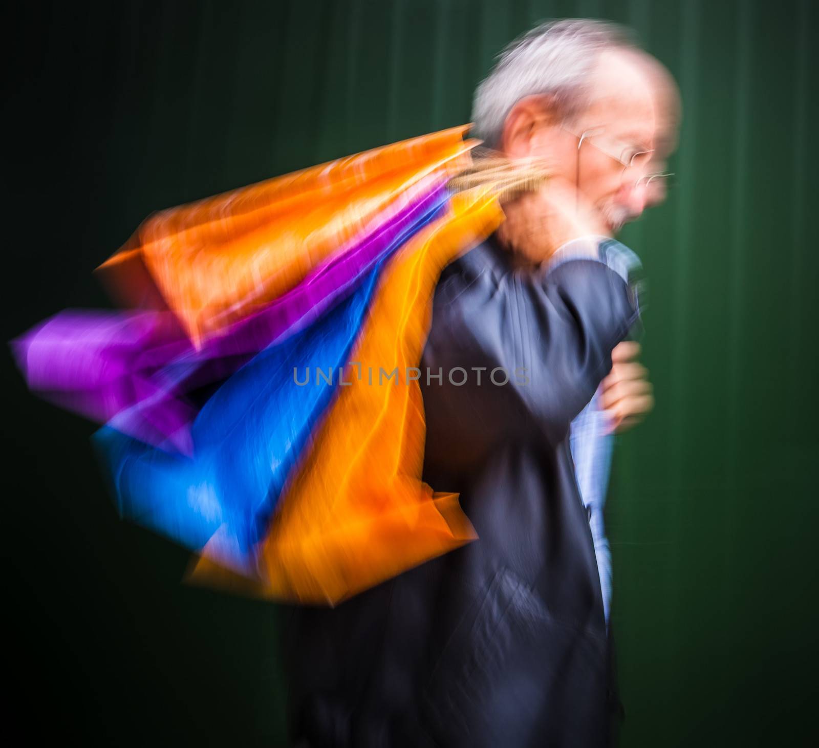 Holiday sales. An elderly man with many shopping bags in his han by palinchak