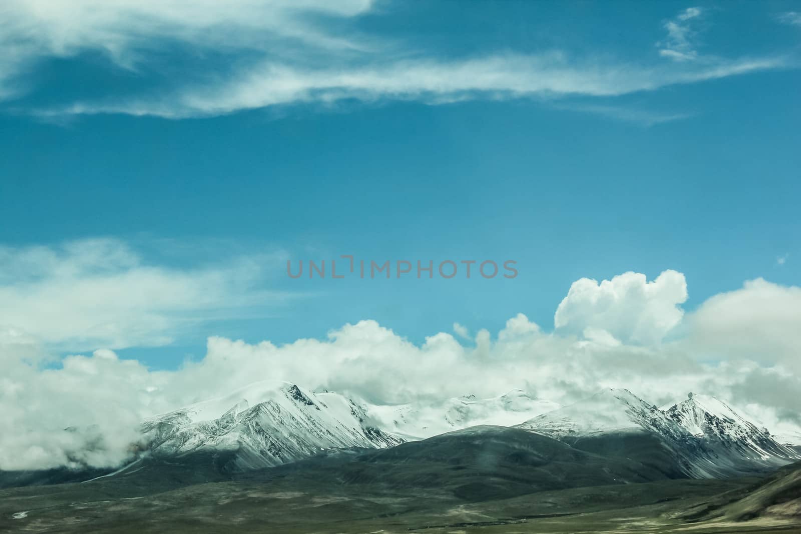 Snow mountains with clouds by IVYPHOTOS