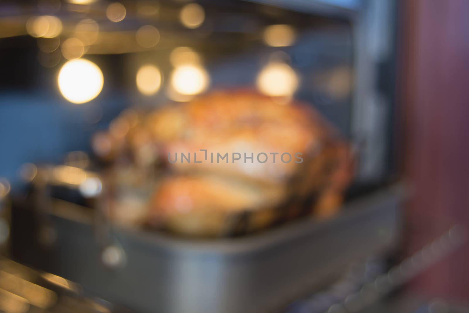 Thanksgiving Turkey in Roasting Pan in Oven Blurred Bokeh Defocused Background