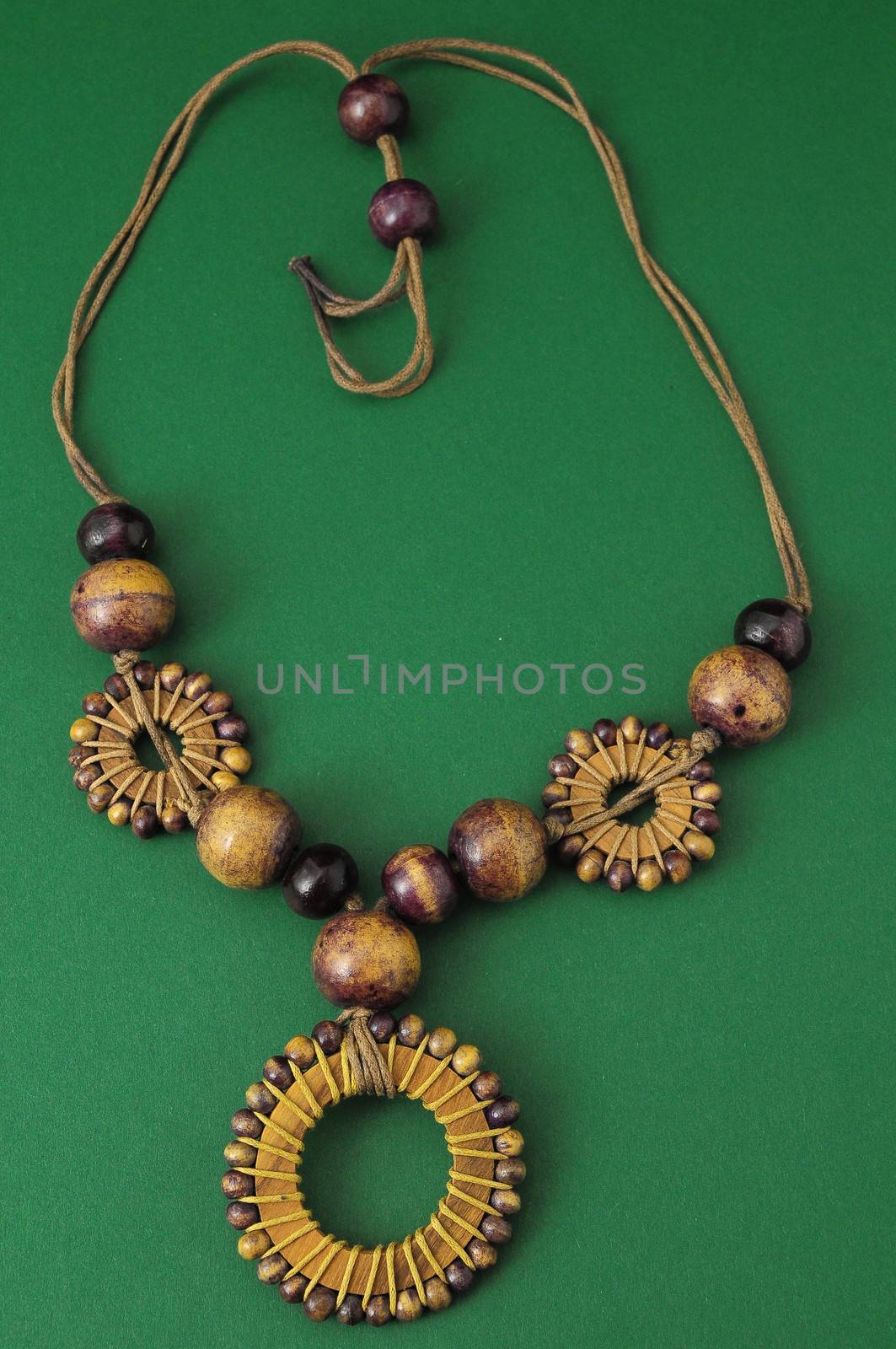 Handmade Wood Collar Necklace on a Colored Background