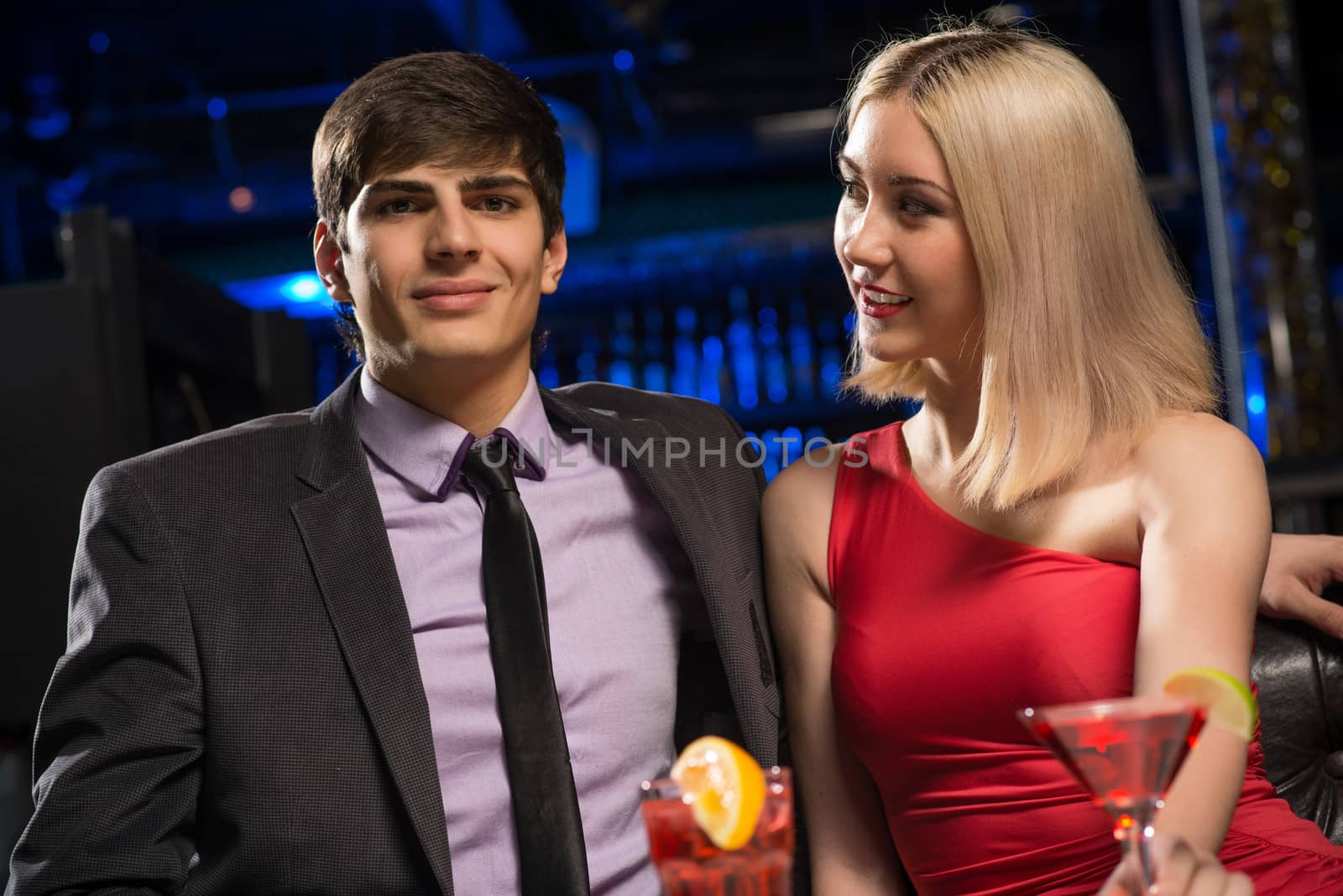 Young couple talking in a nightclub by adam121