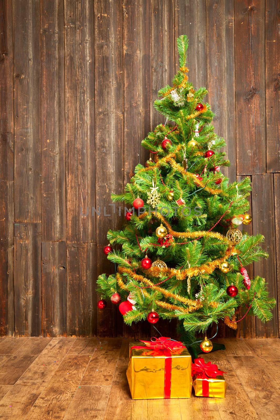 Christmas tree at weathered wooden wall