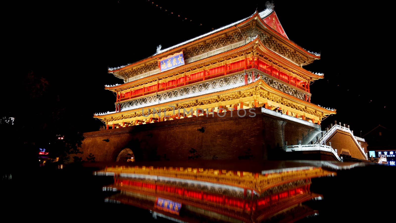 The illuminated ancient Drum Tower located inside the ancient city wall at night time, Xian, Shaanxi Province, China 