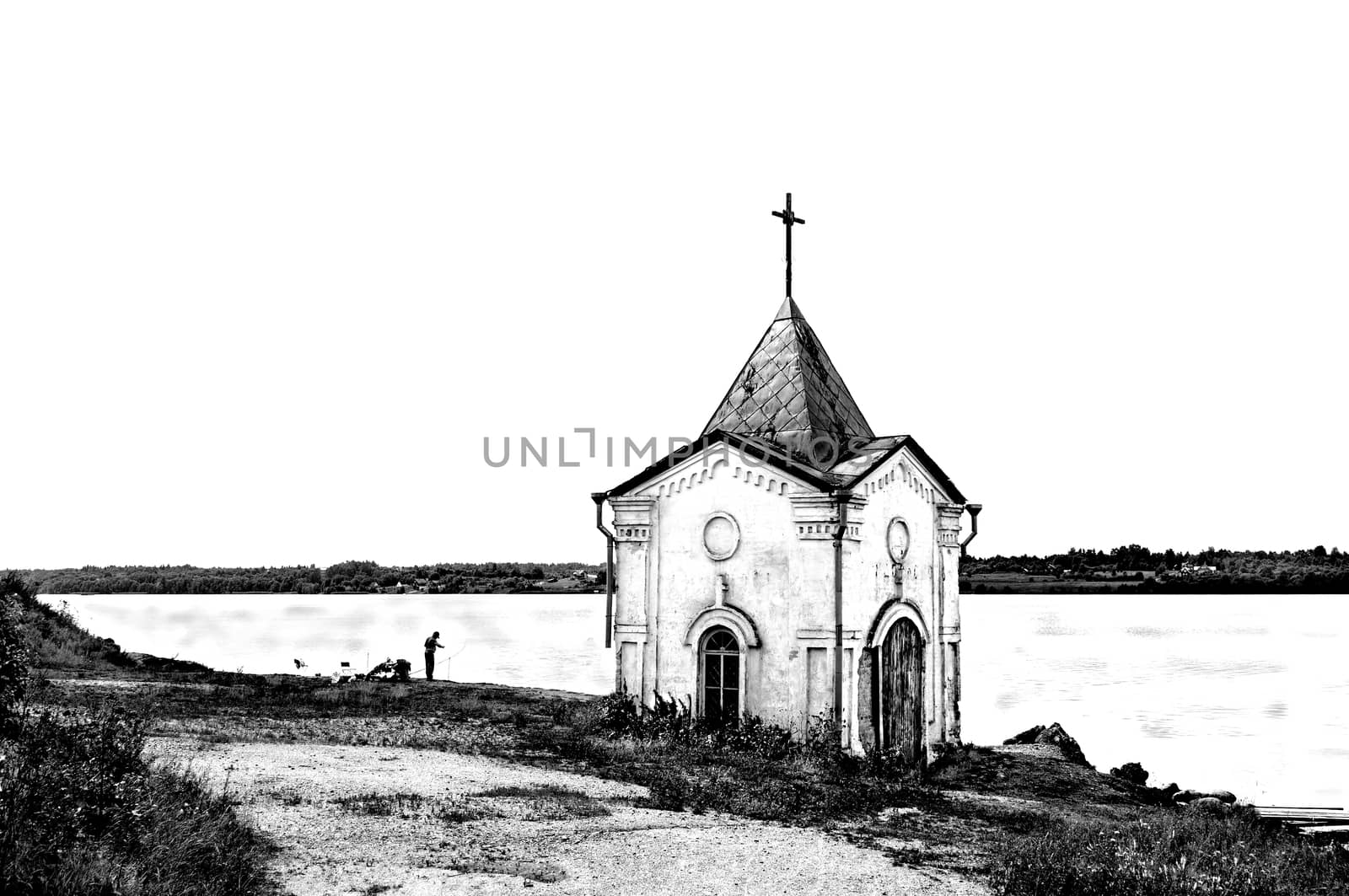 Old chapel on the riverbank in black and white by wander