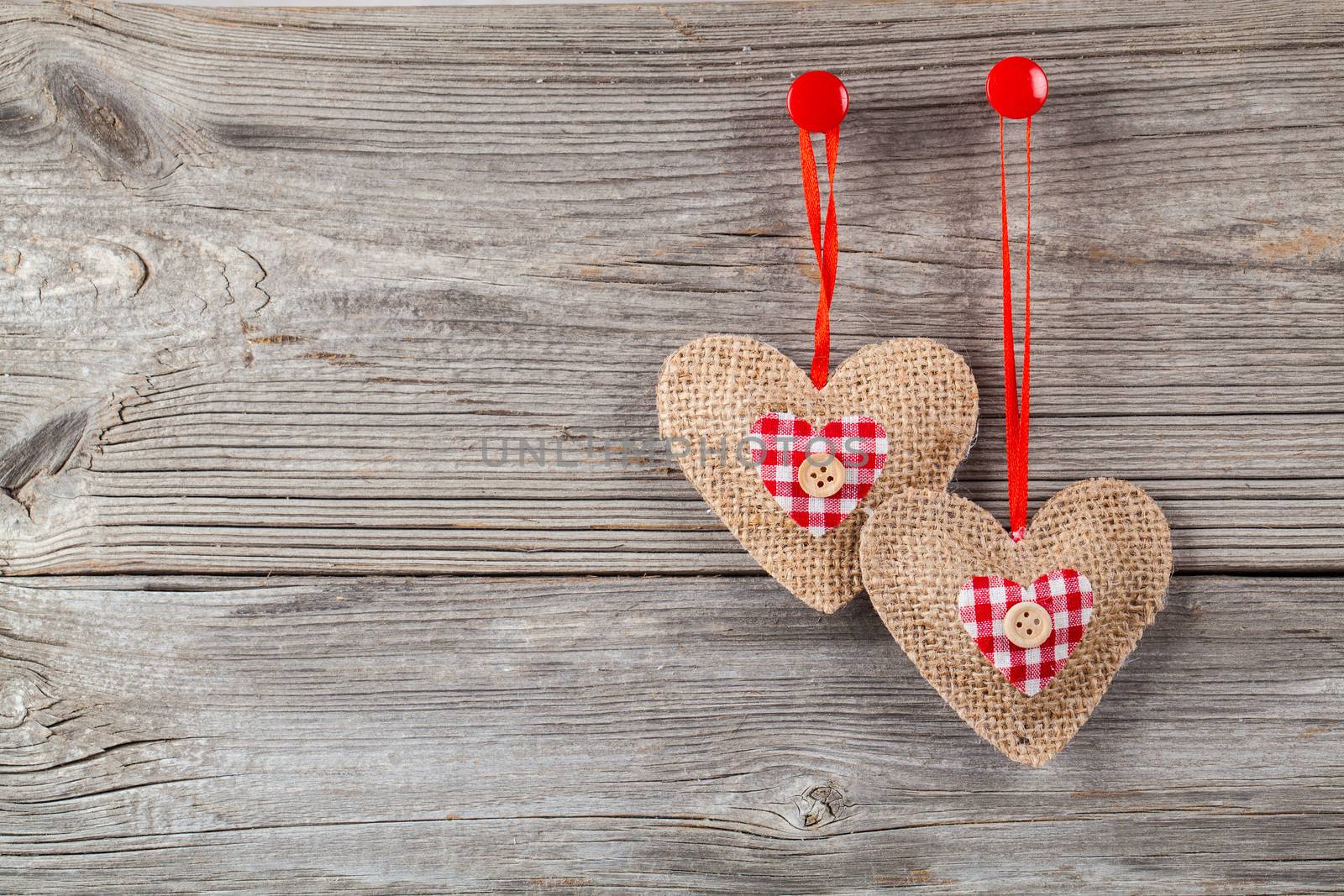 hearts with red bow, on wooden background