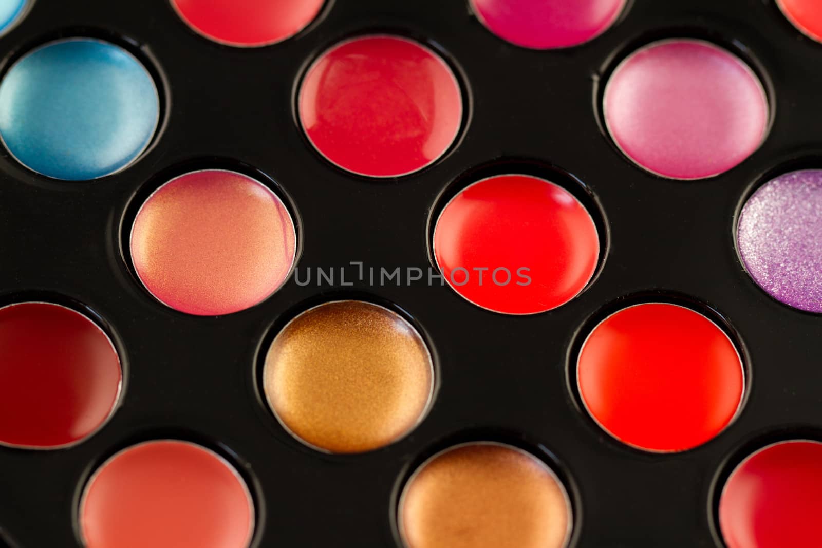 Close-up shot of lip gloss palette, soft focus