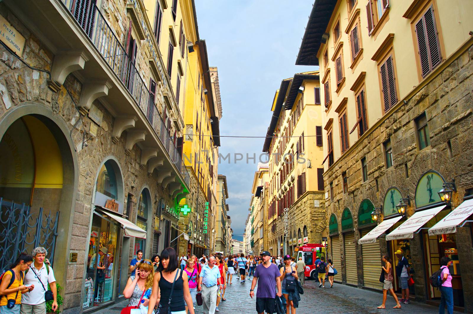 Tourists walking in crowded street in Florence by joyfull