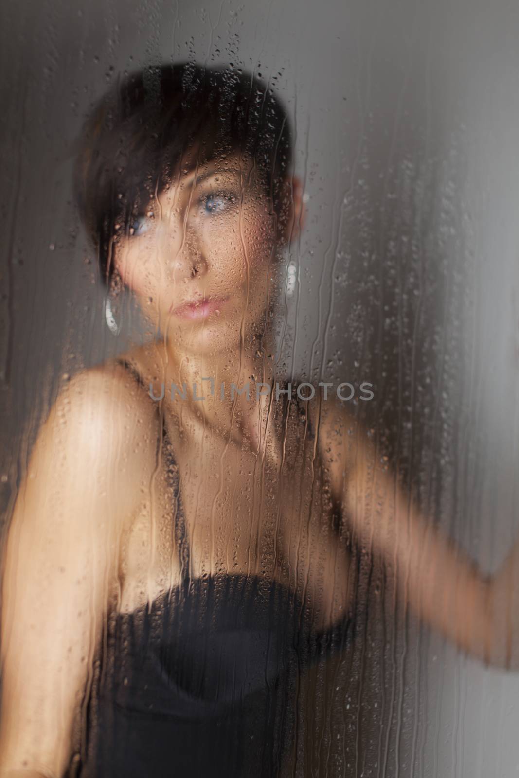 woman behind a rainy window by bernjuer