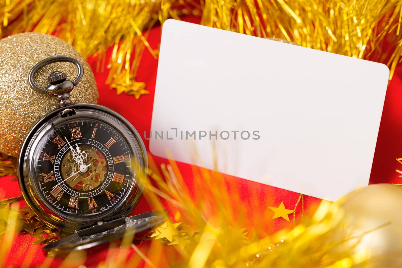 Card on a red background with clock and golden confetti