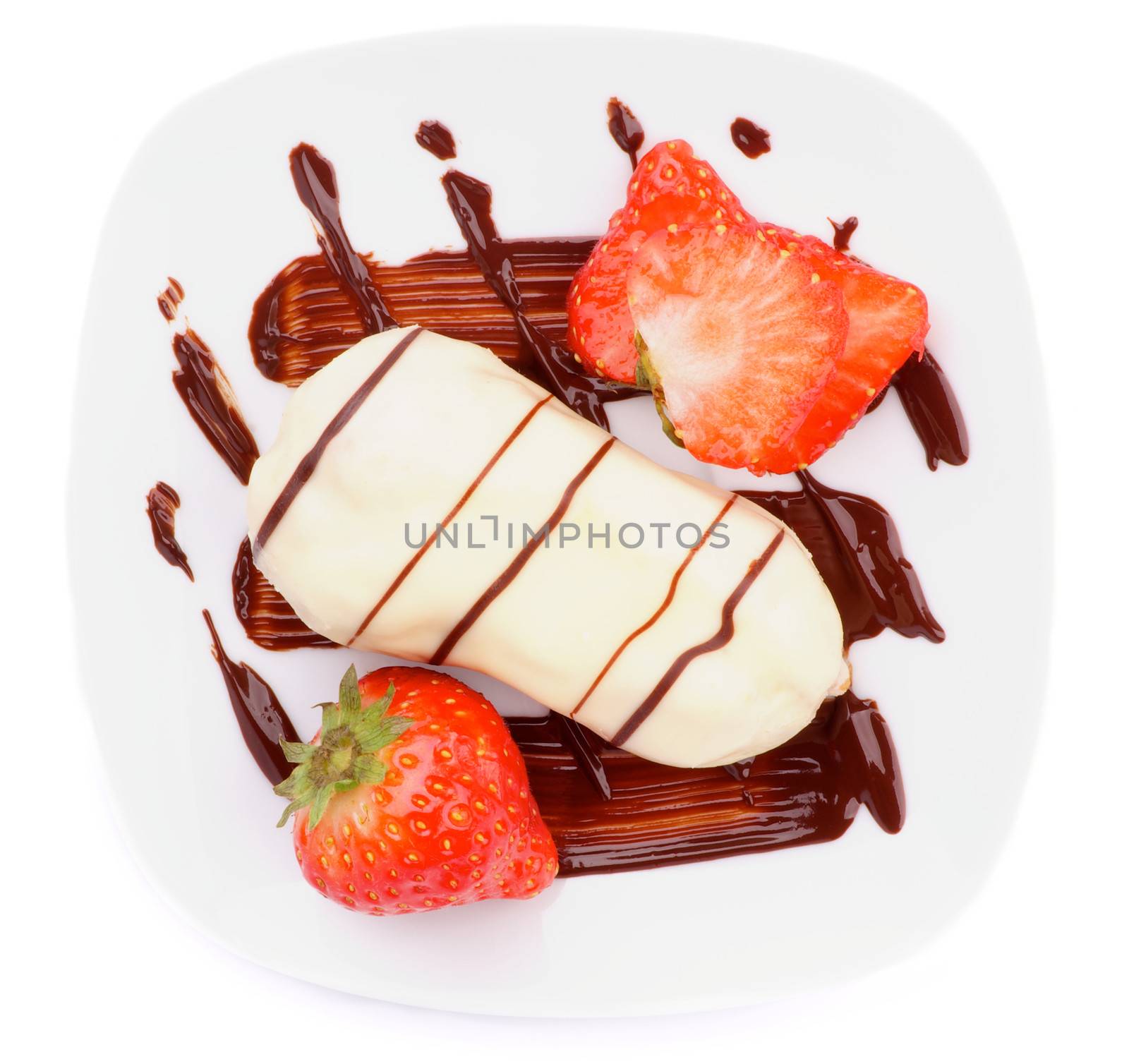 Arrangement of White Chocolate Eclair with Chocolate Sauce and Sliced Strawberry on White Plate closeup on white background. Top View