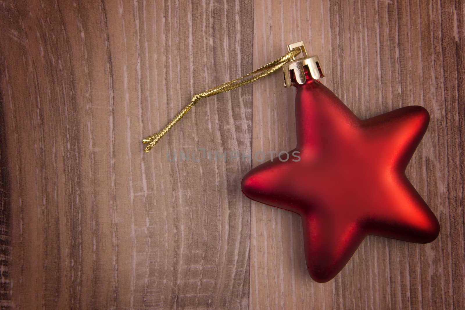 Red Christmas star on wood background 