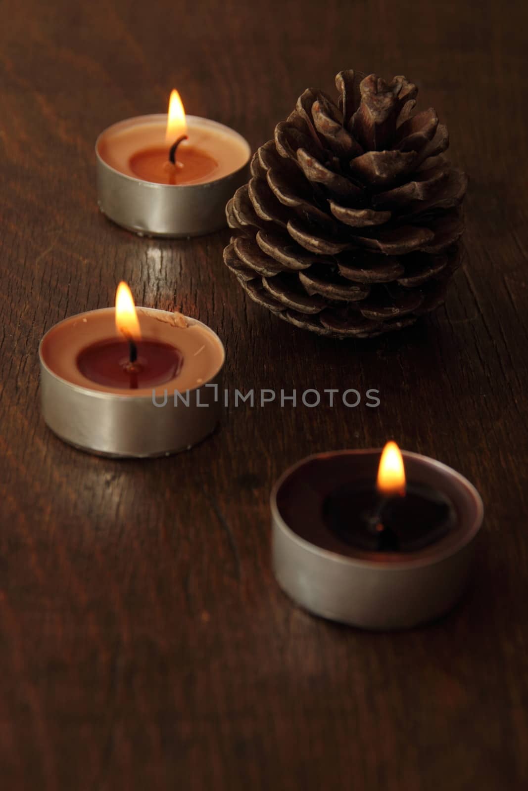 Three candles and bumb in brown tones. Cinnamon and apple