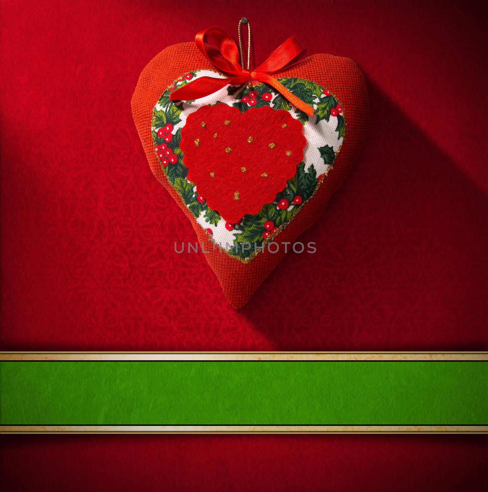 Christmas heart hanging on red velvet background with ornate floral seamless and green plaque