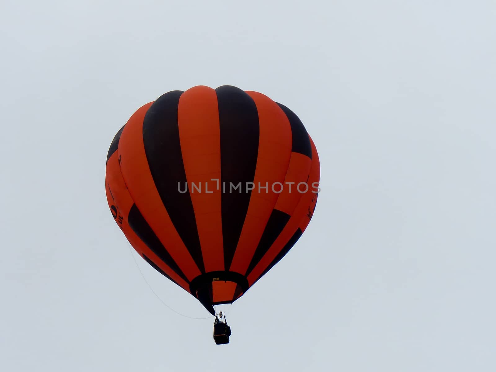 orange striped hot air balloon in flght