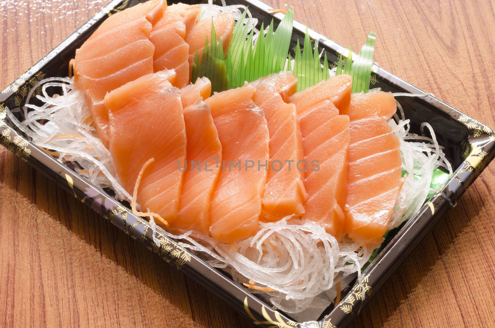 fresh salmon piece for sushi on wood background