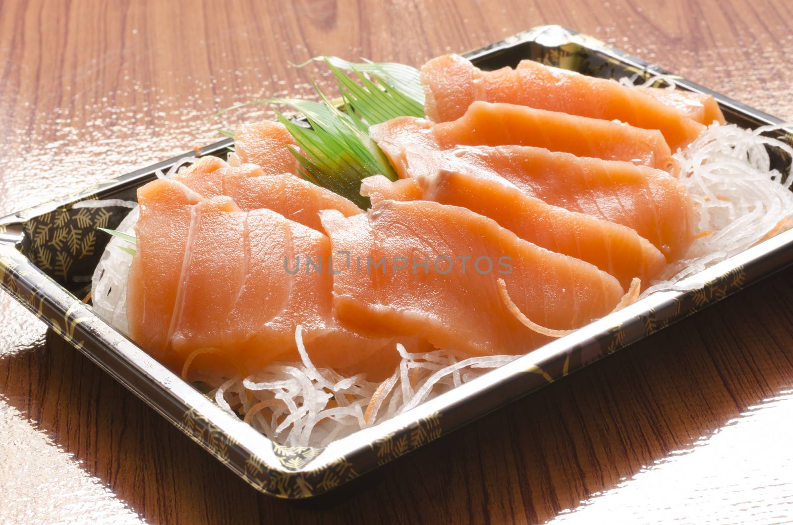 fresh salmon piece for sushi on wood background