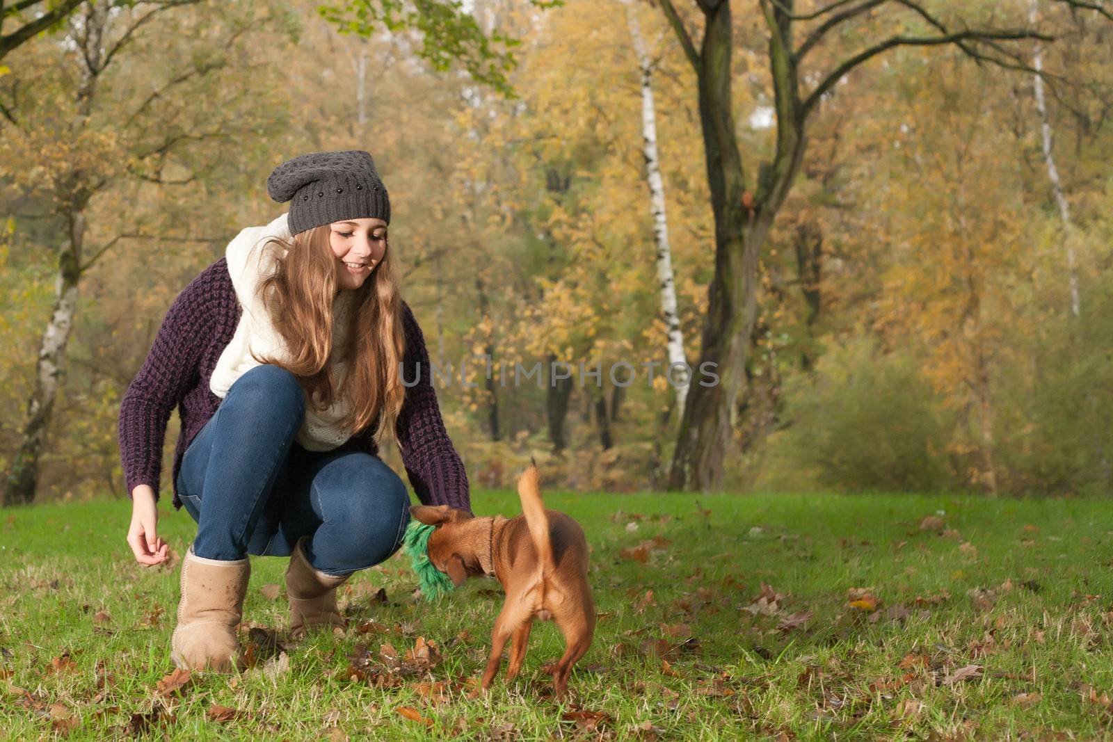 Young teenage girl is having a nice time in the cold november