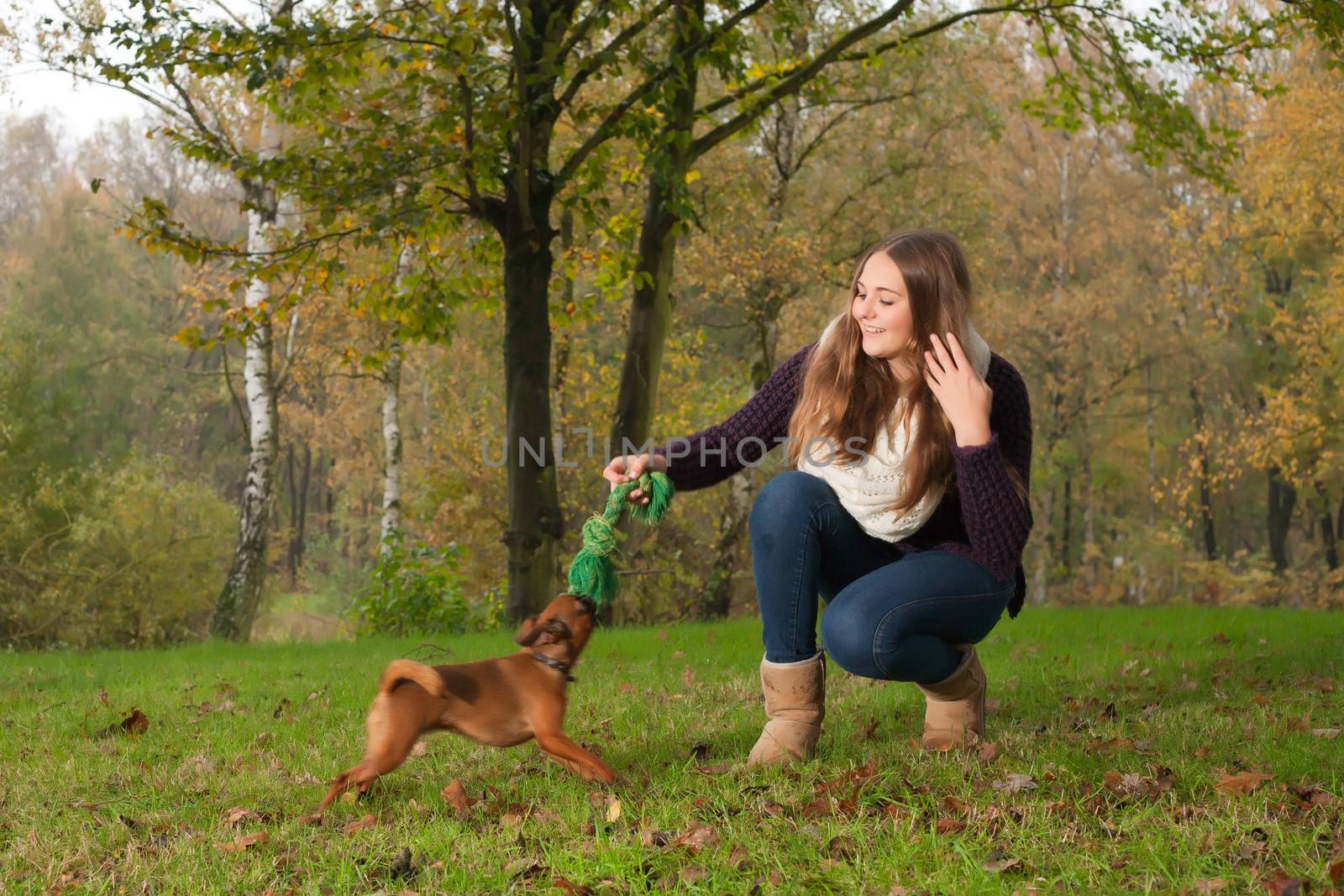 Young teenage girl is having a nice time in the cold november