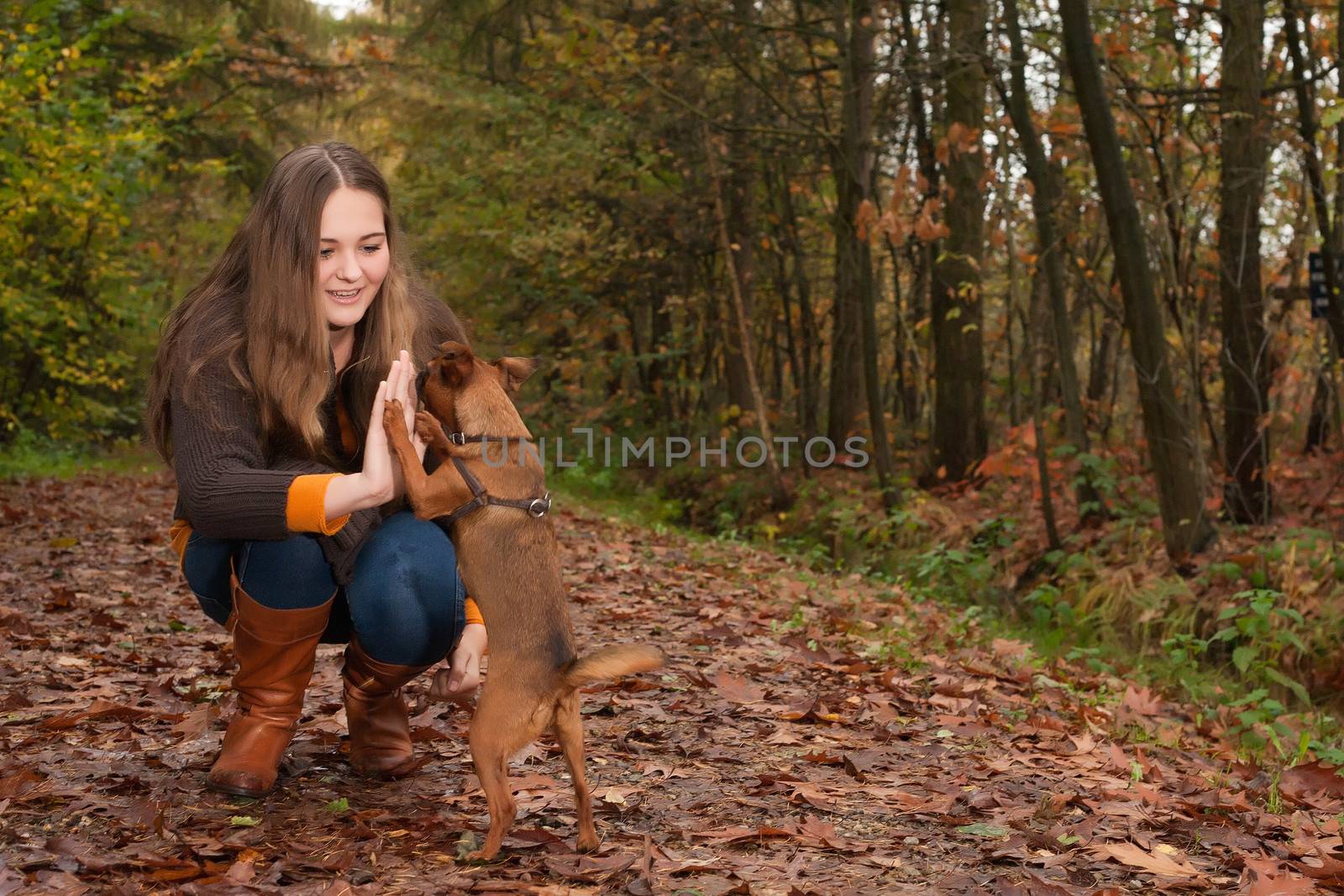 Young teenage girl is having a nice time in the cold november