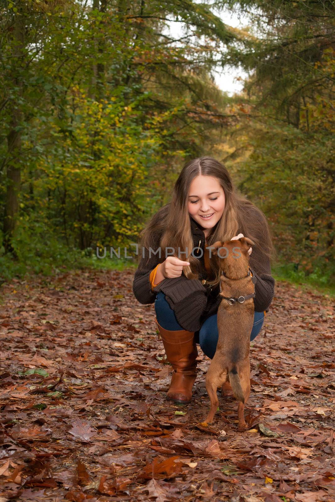 Young teenage girl is having a nice time in the cold november