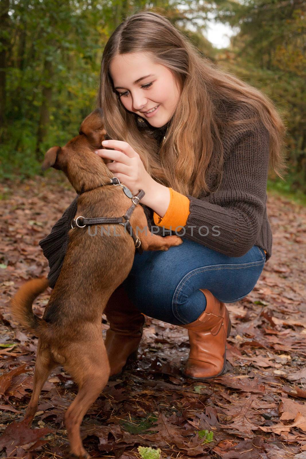 Young teenage girl is having a nice time in the cold november