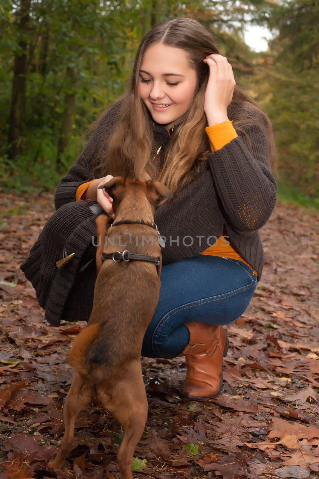 Young teenage girl is having a nice time in the cold november