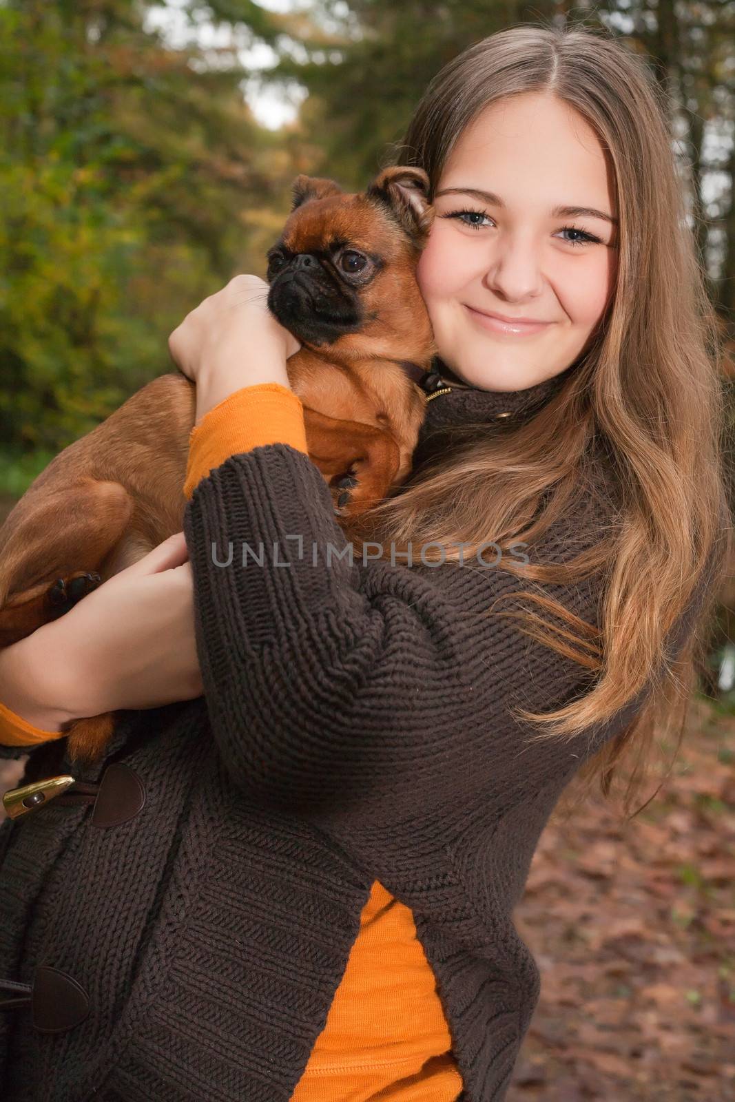 Young teenage girl is having a nice time in the cold november