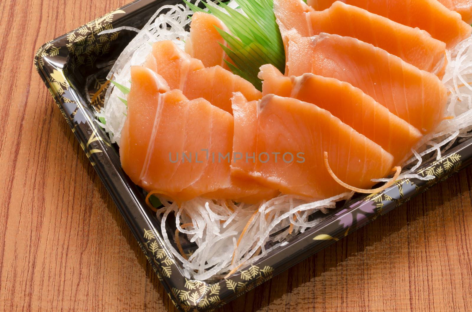 fresh salmon piece for sushi on wood background