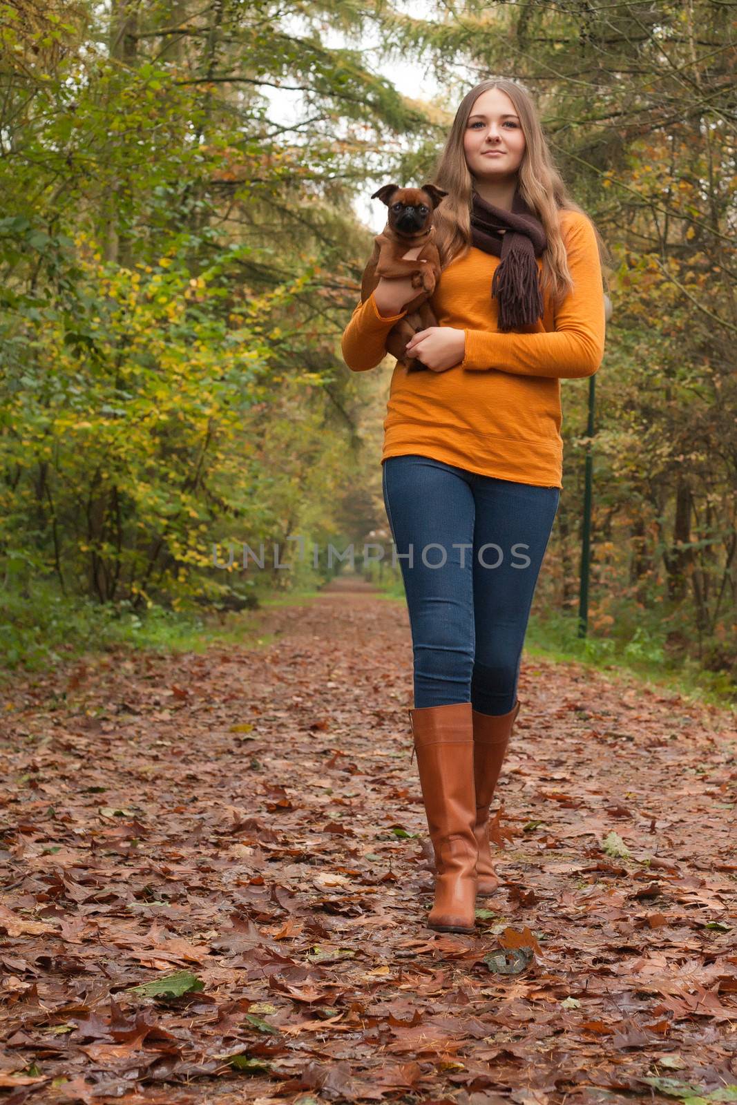 Young teenage girl is having a nice time in the cold november