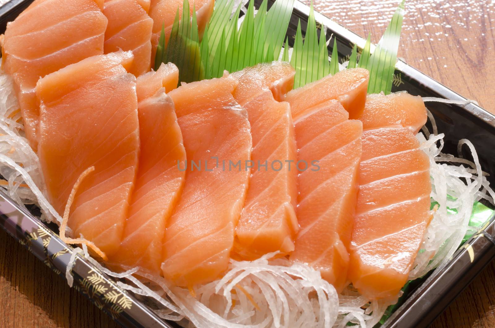 fresh salmon piece for sushi on wood background