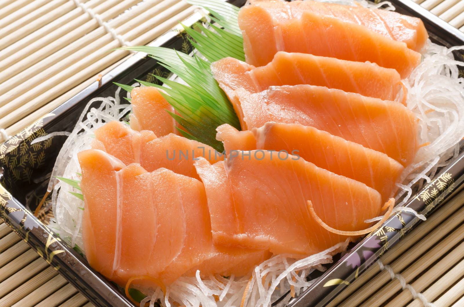 fresh salmon piece for sushi on wood background