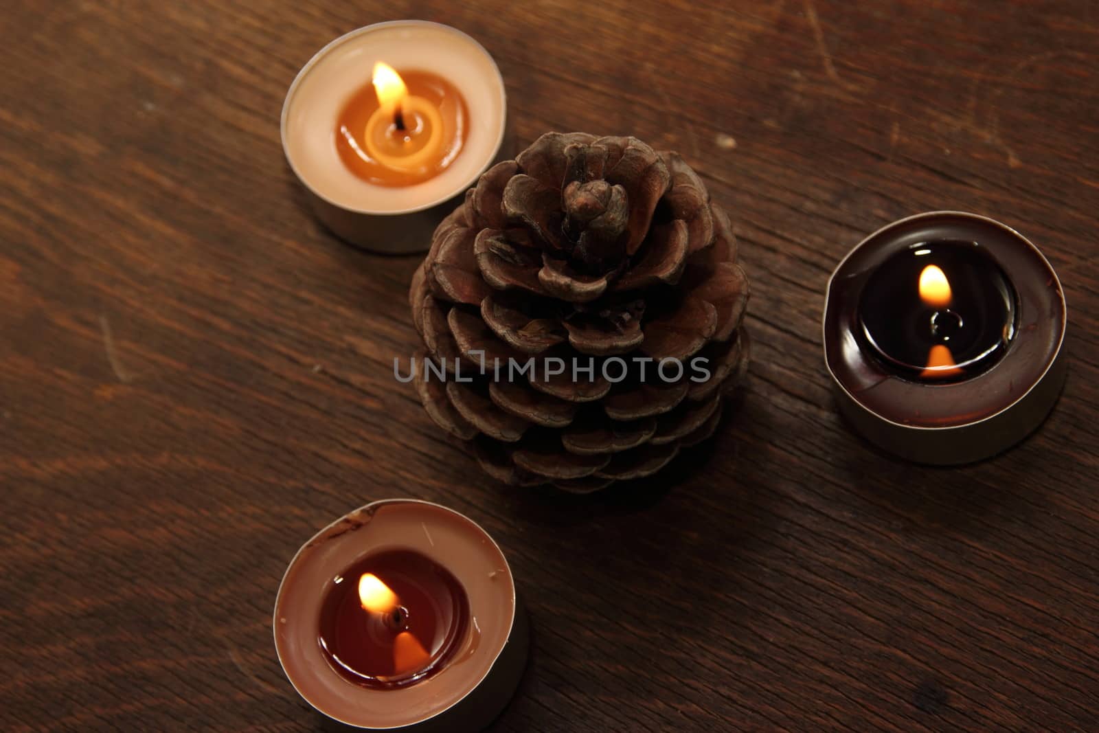Three candles and bumb in brown tones. Cinnamon and apple