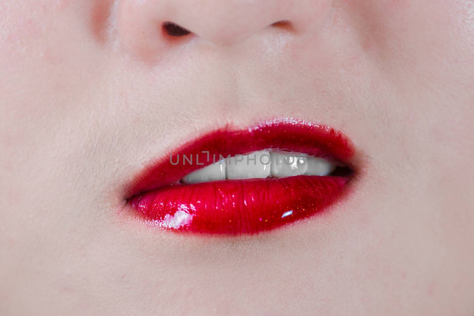 Close up of woman lips with makeup looking disgusted