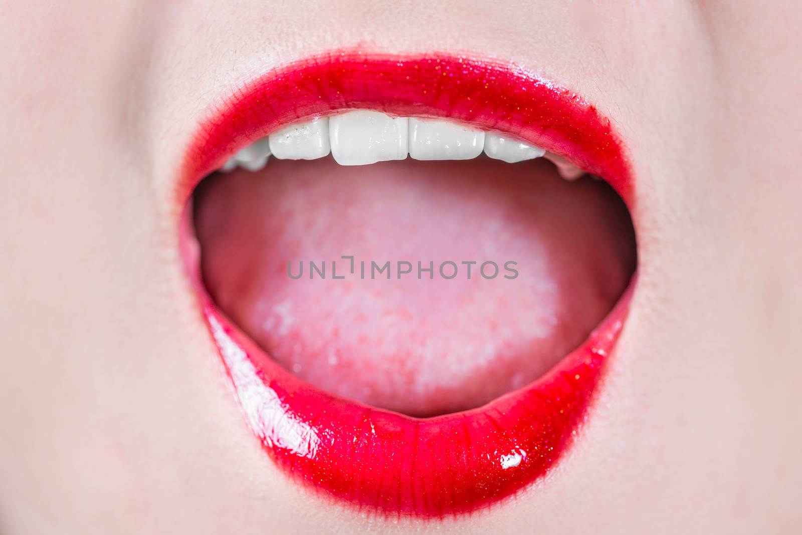 Closeup of woman's lips with makeup laughing 