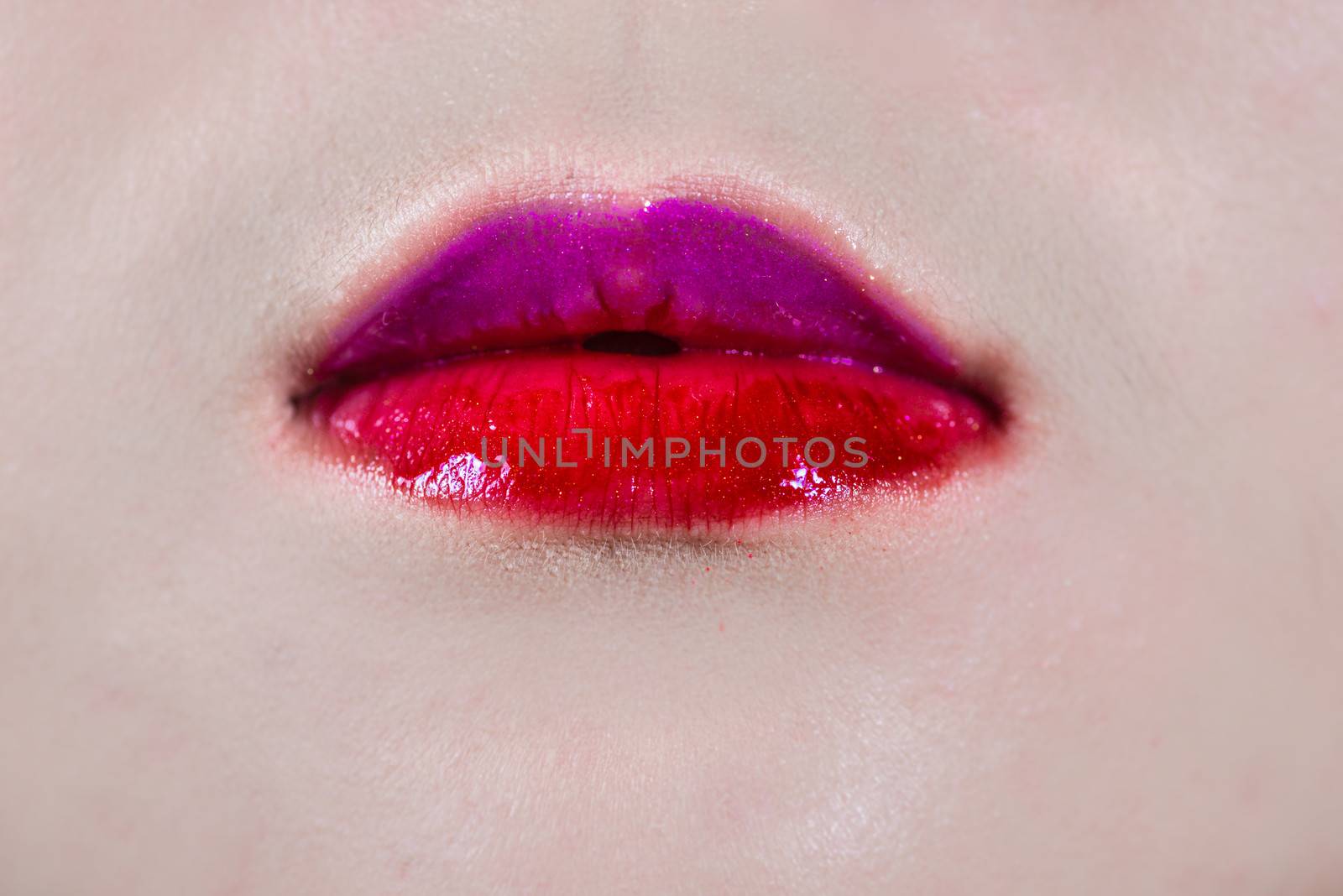 Close up of woman lips with colored lipsticks