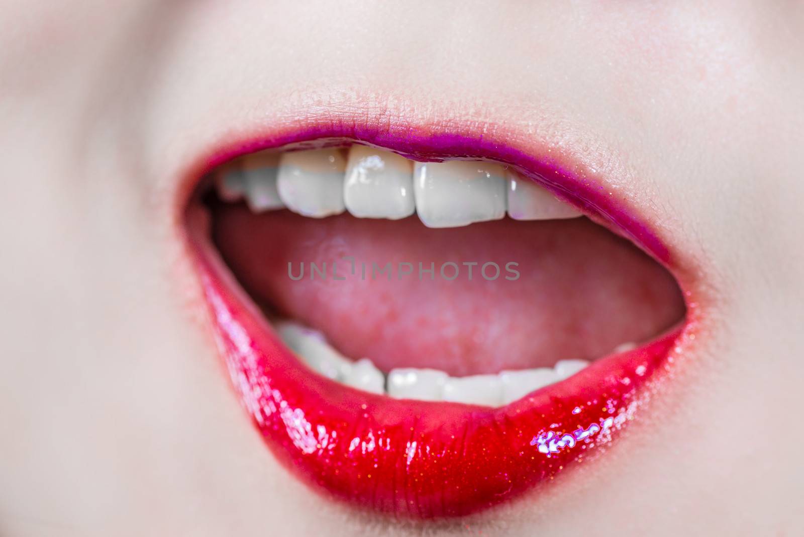 Woman lips with makeup laughing  by IVYPHOTOS