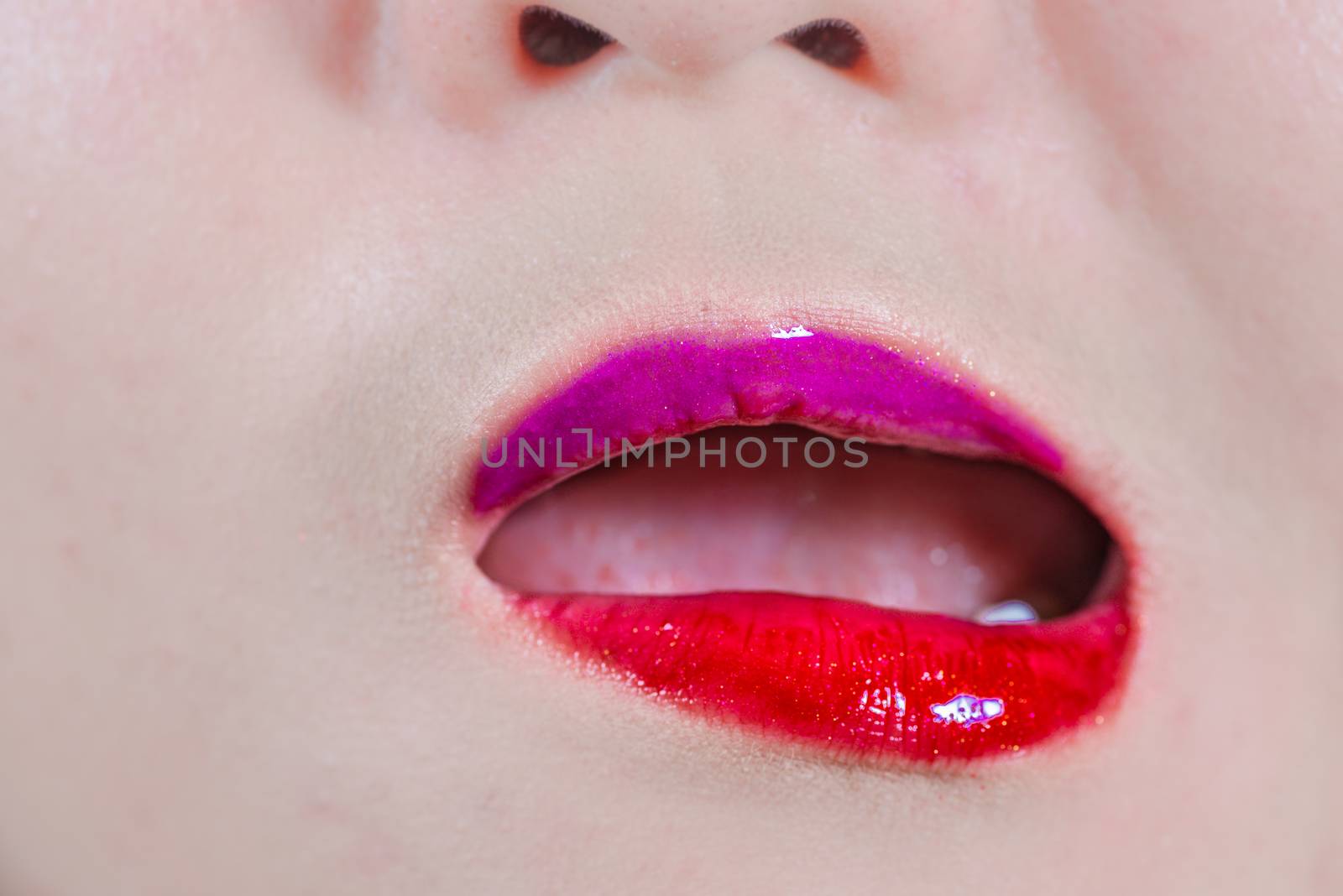 Close up of woman lips with makeup looking disgusted