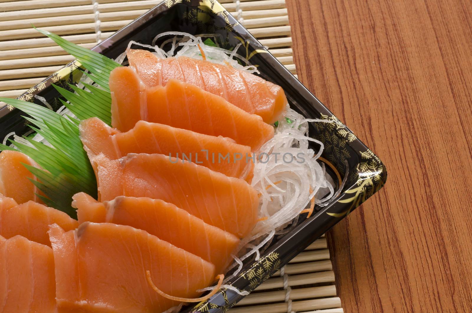 fresh salmon piece for sushi on wood background